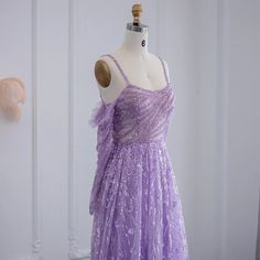 Luxurious Dubai Design: The dress embodies the opulence of Dubai's fashion scene, showcasing elegance and sophistication, making it a perfect choice for upscale events, particularly for wedding parties. Beaded Lilac Detailing: Adorned with intricate beading in a delightful lilac color, the dress exudes opulence and glamour, adding a touch of refinement and sparkle to your ensemble. Elegant Sage Green Long Sleeve Formal Gowns: The dress pairs ideally with sage green long sleeve formal gowns, creating a harmonious and stylish ensemble for any elegant affair. Women's Dress: Designed specifically for women, this dress celebrates femininity and elegance, ensuring you feel beautiful and sophisticated at every moment. High-Quality Craftsmanship: Meticulously crafted with attention to detail and u Floor-length Gown For Debutante Ball Gala, Tulle Gown For Wedding Gala, Tulle Gown For Wedding And Gala, Gala Ball Gown For Debutante Ball, Gala Ball Gown Evening Dress For Debutante Ball, Purple Gown With Sweetheart Neckline For Banquet, Wedding Gala Tulle Gown, Purple Evening Dress With Sweep Train For Banquet, Sequin Fitted Evening Dress For Debutante Ball