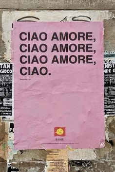 a pink sign on the side of a building that says ciao amore ciao more ciao amore ciao