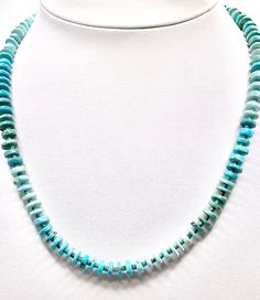 Add a pop of Southwest flair to your jewelry collection with this stunning Turquoise Heishi Necklace. Handcrafted with multi-color turquoise and genuine Arizona turquoise beads, this necklace is a must-have for all Southwest jewelry lovers. Each bead is meticulously strung to create a unique and eye-catching piece that will surely add a touch of bohemian charm to any outfit. Elevate your style with this beautiful turquoise necklace that effortlessly captures the essence of the American Southwest Turquoise Rondelle Beaded Gemstone Necklaces, Turquoise Gemstone Necklace With Round Beads, Turquoise Rondelle Beaded Necklace, Turquoise Rondelle Beaded Necklace Single Strand, Turquoise Single Strand Round Necklace, Turquoise Single Strand Necklace, Single Strand Round Turquoise Necklace, Turquoise Natural Stones Rondelle Necklace, Turquoise Rondelle Necklaces With Natural Stones