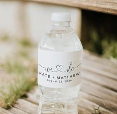 a bottle of water sitting on top of a wooden bench