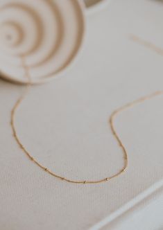 A sweet + delicate layering chain. Offered in 16", 18" or 20" lengths. Available in 14kt Gold Fill + Sterling Silver. Our jewelry is handmade so each piece will be unique and may vary slightly from what is pictured. Dainty 14k Gold Necklace With Delicate Chain, Everyday Delicate Station Necklace With Delicate Chain, Delicate Station Necklace For Everyday Wear, Delicate 14k Gold Necklaces With Delicate Chain, Delicate 14k Gold Filled Chain Necklace, Dainty Station Necklace With Satellite Chain As Gift, Dainty 14k Gold Station Necklace With Cable Chain, Dainty Cable Chain Station Necklace As Gift, Dainty Station Necklace With Cable Chain As Gift