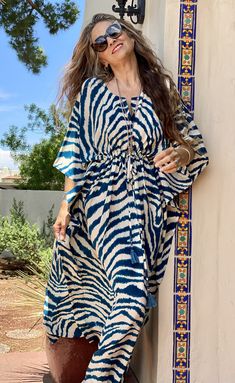 Jean Marie has never met a zebra skin that she did not like! Our Italian silk Zebra Petrolio maxi in this gorgeous petrolium blue color is sure to turn heads! It is the essence of chic and the definition of elegant! Get ready for compliments! This pattern is exclusive to Pax Philomena so you will only find it here! It is printed at one of the most famous Italian fashion mills in the world, where Jean Marie started her career in textiles. We chose this design from the mill's extensive archives an Beach Dress With Zebra Print, Beach Dresses With Zebra Print, Chic Blue Maxi Length Kaftan, Zebra Skin, Maxi Kaftan, Indian Block Print, Silk Maxi, Kaftan Dress, Silk Crepe