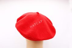 a red hat with the word hatcap written on it