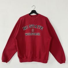 Vintage North Carolina State University Sweatshirt North Carolina Crewneck North Carolina Sweater NC State Wolfpack Embroidered Logo Medium 𝐁𝐫𝐚𝐧𝐝 :- North Carolina State University  𝐒𝐢𝐳𝐞 𝐓𝐚𝐠 :- Medium Manual Measurement :- 𝐖𝐈𝐃𝐓𝐇 (armpit to armpit) :- 22 inches / 56cm 𝐋𝐄𝐍𝐆𝐓𝐇 (shoulder to end of garment) :- 26.5 inches / 67cm 𝐂𝐨𝐧𝐝𝐢𝐭𝐢𝐨𝐧 :- Good Condition 8/10.                      - No Hole, No Stain.  - Colors Might Be Different Due To Lighting. - All items are VINTAGE which show some signs of wear and tear FEDEX EXPRESS = 3-6 business day arrived Red Collegiate Cotton Sweater, Collegiate Crew Neck Top With Embroidered Graphics, Collegiate Crew Neck Top With Embroidered Logo, Collegiate College Tops With Embroidered Logo, Collegiate Tops With Embroidered Graphics For College, Collegiate Tops With Embroidered Logo For College, Crew Neck Top With Embroidered Logo For College, Casual Embroidered Tops For College, Winter College Sweater With Embroidered Graphics