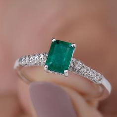 Product Details This classic engagement ring features a stunning octagon shape emerald center stone, with diamond side stones for added sparkle. The emerald is of AAA quality, with a deep green color and excellent clarity. The rings band is made of high-quality materials and designed to showcase the beauty of the center stone. This elegant and timeless design is perfect for those seeking a sophisticated and classic engagement ring that will never go out of style. Product Information SKU SHP-RINGS0822466006 Width 5.2 mm Height 7 mm Weight 1.84 gm (Approximate) EMERALD INFORMATION No.of Stones 1 Pieces Total Weight 0.66 Carat (Approximate) Dimension(approx) Emerald Cut-4X6 mm-1 Pcs Color Green Cut Brilliant Shape Emerald Cut Setting Type Prong-Setting Quality Grade AAA DIAMOND INFORMATION No Octagon Emerald Ring With Diamond Accents, Diamond Octagon Emerald Ring For Anniversary, Diamond Emerald Ring For Anniversary With Octagon Shape, Octagon Emerald Ring With Diamond For Anniversary, Classic Emerald Ring With Diamond Accents And Octagon Shape, Classic Octagon Emerald Ring With Diamond Accents, Octagon Emerald Ring With Diamond, Elegant Octagon Emerald Ring With Accent Stones, Octagon Emerald Ring With Diamond For Promise