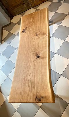 a wooden bench sitting on top of a checkered floor