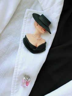 Elegant woman in black titfer hat. The brooch made of polymer clay. There are 3 ruby stones in a perfume bottle. This is my second C*co style brooch. Always stay beautiful and charming in your favorite clothes! Black Brooch Lapel Pin As Gift, Chic Evening Jewelry Brooch, Chic Evening Brooch Jewelry, Black Lapel Pin Brooch As Gift, Black Lapel Pin Brooch For Gift, Vintage Black Lapel Pin As Gift, Vintage Black Lapel Pin For Gift, Black Vintage Lapel Pin For Gift, Handmade Elegant Black Brooches