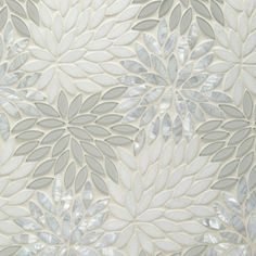 a white wallpaper with silver leaves on it