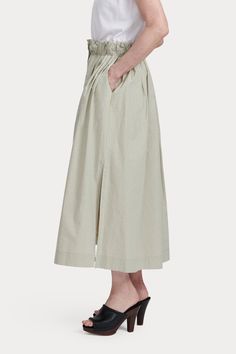 Airy midi skirt featuring deep slip pockets, a broad elastic waistband, and high side slits. Concealed buttons run down the skirt's center. Cut from our signature Organic Crisp Cotton - capable of both structure and ease, ideal for lightweight summer tailoring. 100% Cotton Side slip pockets Side slits Concealed button-front closure Made in USA Relaxed Maxi Skirt With Pockets For Daywear, Long Skirt With Pockets For Daywear, Relaxed Fit Midi Skirt For Daywear, Relaxed Spring Skirt With Slip Pockets, Spring Workwear Skirt With Side Slits, Relaxed Fit Gathered Skirt Midi Bottoms, Relaxed Fit Midi-length Gathered Skirt, Asymmetrical Relaxed Skirt For Daywear, Relaxed Fit Midi Length Gathered Skirt