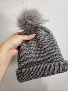 This winter hat is perfect for a young child to wear outside in the cold.   Machine knitted by me. Pom pom is secured around a button on top of hat for easy removal for washing. Measures 7 inches tall when brim is folded up.  And approximately 18 inches wide. Perfect for 2 to 4 year old.  Maybe even 5 year old. Casual Gray Crochet Hat For Cold Weather, Cozy Gray Soft Knit Hat, Gray Winter Crochet Hat With Soft Knit, Winter Gray Crochet Hat With Soft Knit, Gray Soft Knit Crochet Hat For Winter, Gray Soft Knit Crochet Beanie, Warm Gray Beanie, Cozy Warm Gray Beanie, Cozy Gray Warm Hat