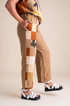 Stand out in our Patchwork Sunset Pants—a one-of-a-kind masterpiece crafted from a collection of cotton and linen fabric scraps we've carefully saved throughout the year. These unique pants are perfect for transitioning effortlessly between summer and fall, and back again. Features: One-of-a-Kind Design: Each pair is a unique patchwork of carefully selected fabric scraps. Versatile Styling: Ideal for shifting seasons, blending summer ease with autumn warmth. Pull-On Comfort: Easy to wear with a Brown Patchwork Summer Pants, Summer Brown Patchwork Pants, Brown Patchwork Pants For Summer, Brown Patchwork Long Pants, Patchwork Relaxed Fit Ankle-length Bottoms, Cotton Pants With Patchwork, Cotton Patchwork Wide-leg Pants, Cotton Patchwork Straight Pants, Brown Bottoms With Patch Pockets For Summer