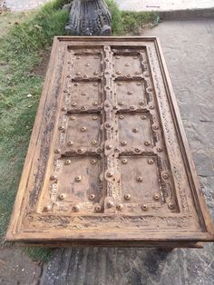 an old wooden door sitting in the grass