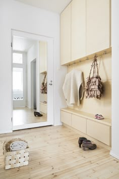 the entryway is clean and ready to be used as a shoe storage area for shoes