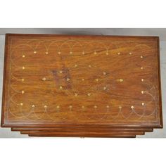 a wooden tray with gold decorations on it