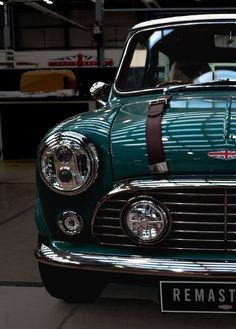 an old green car with a bow on it's front end and the hood