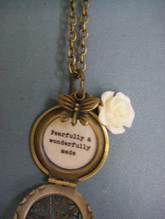 Small locket necklace features a lovely ivory resin rose and bronze butterfly dangle. It opens to the words, 'fearfully and wonderfully made' in vintage typewriter font and professionally sealed inside-- The filigree brass locket measures 27mm and hangs on a brass chain. You may choose your desired length at checkout. It will arrive beautifully packaged, ready for gifting. Not intended for water submersion. Vintage Personalized Charm Necklaces As Gift, Personalized Vintage Charm Necklaces As Gift, Vintage Personalized Charm Necklaces For Jewelry Making, Personalized Vintage Charm Necklaces For Gift, Vintage White Charm Necklaces, Vintage Locket Charm Necklace For Mother's Day, Vintage Adjustable Necklace For Mother's Day, Vintage Birth Flower Necklaces For Jewelry Making, Vintage Brass Charm Necklace For Gift