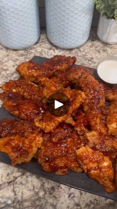 chicken wings on a plate with dipping sauce