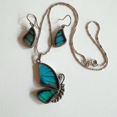 These amazing set of butterfly earrings and necklace are very special as they are made from real butterfly wings!  They are reversible so you can see the colour on one side and browns on the underside. Very unique set for the butterfly lover!  Price is for the set of earrings and necklace. Size: Pendant - 18" chain, pendant 1.5" drop, Earrings 1 1/2" drop Condition - Excellent MARKING: 950 (which has a higher silver content than 925) To see my other jewelry, click here: https://etsy.me/3A8crke T Silver Jewelry With Butterfly Charm, Elegant Turquoise Butterfly Jewelry, Silver Butterfly Jewelry With Matching Earrings, Unique Butterfly-shaped Jewelry With Matching Earrings, Blue Butterfly Sterling Silver Jewelry, Turquoise Butterfly Sterling Silver Jewelry, Unique Sterling Silver Jewelry With Butterfly Charm, Turquoise Butterfly Jewelry For Gifts, Turquoise Butterfly Jewelry For Gift