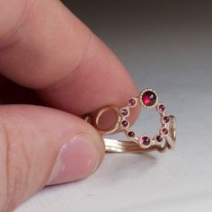 Luxurious Gold Ring set with Beautiful Red Garnets from India. Hand crafted then Set with 10 Cabochon Red Garnets in 3 different Sizes. Truly Excellent ring made in a unique style like no other. The Shank is made of designer Gold Hoops that are becoming smaller and smaller towards the back. All ring sizes available, Other gemstones Available upon request. This ring is 1.3-1.7mm thick depending where you measure and 13,5mm wide at the widest point at the front. Questions are welcome and are answe Ombre Rings, Sapphire Eternity Ring, Red Garnet Ring, Purple Amethyst Ring, Green Stone Rings, Blue Stone Ring, Gold Ring Sets, Half Eternity Ring, Garnet Ring