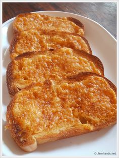 two pieces of toast sitting on top of a white plate