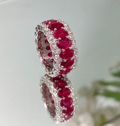 Brand new ruby and diamond eternity band - a must-have piece for your complete ring stack! Perfectly matched 6x4 mm rubies are set in a well crafted eternity style in 18K white gold surrounded by diamonds. DETAILS ❤️Ruby Weight: 9.17 CT 📏Ruby Measurements: 6x4 mm 💎Diamond Weight: 1.52 CT 💍18K White Gold 🎂Birthstone: July STYLES This ring can be made to order in precious gemstones such as emerald and sapphire. CUSTOM ORDER We customize high jewelry made with quality gemstones and diamonds. Pl Rubies And Diamonds Ring, Red Ruby Diamond Ring, Ruby Jewelry Ring, Ring Photoshoot, Ruby Eternity Ring, Ruby Eternity Band, Rubin Ring, Birthday Stone, Jewelry Ruby