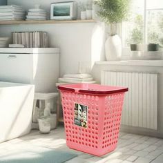 a pink laundry basket sitting on the floor