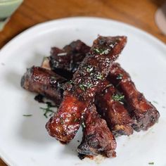 some meat is sitting on a white plate