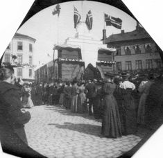 an old black and white photo of people standing in front of a building with flags on it