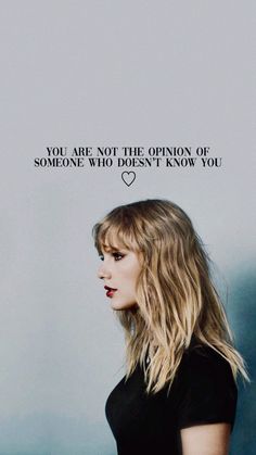 a woman with long blonde hair standing in front of a gray wall and the words you are not the opinion of someone who doesn