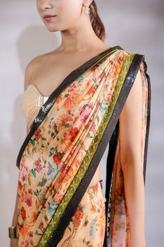 Multicolor floral print and sequin panel half half pre draped saree. Comes with padded tube blouse.
Components: 2
Pattern: Printed
Type Of Work: Floral
Neckline: Sweetheart
Sleeve Type: Sleeveless
Fabric: Georgette, Sequin georgette
Color: Multi Color
Other Details: 
Blouse front buckle detail
Length:
Blouse: 14.5 inches 
Saree :43  inches 
Model Height: 5ft 8inches wearing size S
Closure: Saree: Side zip
Occasion: Sangeet,Mehendi and Haldi - Aza Fashions Bollywood Style Fitted Pre-draped Saree With Floral Print, Fitted Pre-draped Saree With Floral Print For Festive Occasions, Festive Pre-draped Saree With Floral Print And Traditional Drape, Festive Pre-draped Saree With Floral Print, Traditional Pre-draped Saree With Floral Print For Party, Floral Print Pre-draped Saree For Navratri Party, Festive Floral Print Pre-draped Saree, Floral Print Georgette Choli With Traditional Drape, Georgette Choli With Floral Print And Traditional Drape