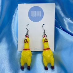 We have the most iconic earrings of all time - mini rubber chicken earrings! Our unique rubber chicken earrings are a fun way to make your outfits more interesting and everyone will be 'chicken' you out! Please note: these earrings do not make a sound when squeaked. Approximate Dimensions (Excluding Hooks): Height: 6.2cm Width: 2.2cm Material: Rubber Care instructions: For best results, please keep these away from water, perfume and other chemicals. Store in a cool, dry place. Disclaimer: Our earring hooks are typically friendly on the skin, however they may not be suitable for hyper-sensitive and hyper-allergic skin. This includes our stainless steel and sterling silver earrings. Funny Earrings Hilarious, Strange Earrings, Weird Earrings Aesthetic, Chicken Earrings, Crazy Earrings, Weird Earrings, Rubber Chicken, Funny Earrings, Water Perfume