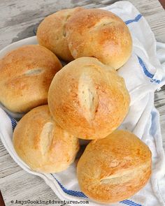 a bunch of bread rolls sitting on top of a white plate with the words, brother german hard rolls