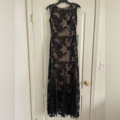 a black dress hanging on a white door