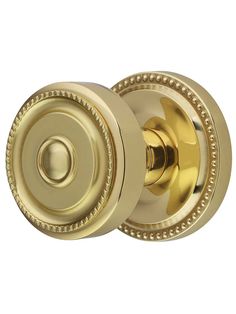 an antique brass door knob with beading on the front and side, is shown