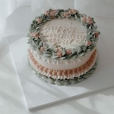 there is a wedding cake with flowers on the top and frosting in the middle