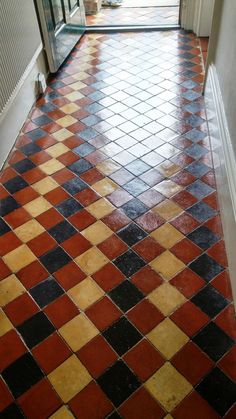 an orange and black checkered floor in a hallway