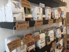 there are many bags of coffee on the shelves