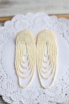 "Wedding bridal earrings Gold ivory bohemian fringe earrings Statement boho chandelier tassel dangle seed beaded Size: length - 10cm (4 inches) width - 3.5 cm (1.5 inches) ❤ CUSTOM ORDERS It is ABSOLUTELY HANDMADE . So if you like this item in a different color or size, send me a message please. I will send you a link for a \"custom order\" and you'll be able to place the order there. Please feel free to communicate with me. SHIPPING Item will be shipped carefully packed in a GIFT BAG!! Shipping White Pearl Beaded Bohemian Earrings, Bohemian Chandelier Earrings With Pearl Drop, Bohemian White Pearl Beaded Earrings, Bohemian Chandelier Pearl Drop Earrings, Bohemian Bridal Earrings For Wedding, Elegant Beaded Fringe Dangle Chandelier Earrings, Bohemian Long Drop Chandelier Earrings With Tassels, Bohemian Chandelier Earrings With Fringe, Bohemian Bridal Earrings With Pearl Drop Dangle