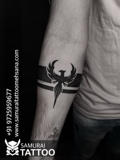 a man's arm with a tattoo on it that has a bird and cross