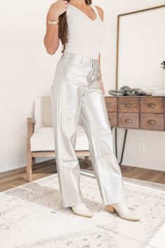 These sleek and stylish pants are made with high-quality silver leather, making them not only fun, but also durable. Perfect for adding a pop of uniqueness to your outfit, these pants are sure to turn heads and make a statement. Model is 5'5 wearing a size small XS 0-2, S 2-4, M 4-6, L 8-10 55% Polyurethane, 45% Polyester Faux leather material High-waisted Wide leg fit Silver Leather Pants, Leather Making, Stylish Pants, Jumpsuit Shorts Rompers, Short Jumpsuit, Dress Romper, Leather Material, Outerwear Jackets, Short Sets