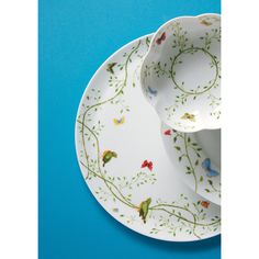 two white plates with birds painted on them