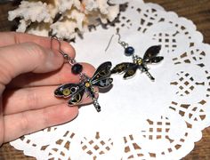 Steampunk earrings in the form of black dragonflies with real watch parts will be an excellent accent of your image. Jewelry is made of metal bases, wings are painted by hand, decorated with shiny watch details and covered with clear glaze , a crystal black beads complements earrings. Jewelry amazing sparkle in the sun. Length of earrings 5.5 cm, width 4.5 cm. ( 2.15* 1.8 Inches). Weight of pair 9 grams See also dragonfly earrings in different colors: https://www.etsy.com/listing/521156438 Earri Black Hypoallergenic Bohemian Jewelry, Black Bohemian Hypoallergenic Jewelry, Unique Black Hypoallergenic Jewelry, Wanderlust Jewelry, Steampunk Earrings, Dragonfly Jewelry, Dragonfly Earrings, Watch Parts, Blue Gift