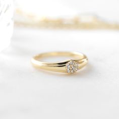 a diamond ring sitting on top of a white surface