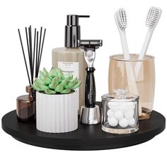 an assortment of bathroom accessories including toothbrushes, soap dispenser and candles