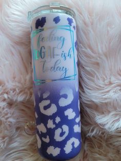 a blue and white leopard print tumbler with the words feeling dog - ash today on it