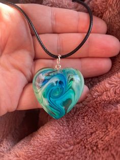 One of a kind, heart shaped pendant created with alcohol inks and resin. This particular one evokes feelings of coastal vibes. The pendant comes on a black adjustable cord necklace. ♡ RECIPIENT IDEAS: - Daughter - Gift for Wife  - Stocking stuffer - Mom ♡ EXTRAS: If you like this listing but it isn't exactly what you're looking for, check out this listing that I think you'll love!: https://www.etsy.com/listing/1116964023/oval-sea-glass-resin-pendant-pendant?click_key=6b54d081ce35d69232552d5ef789 Resin Heart Charm Necklace Gift, Artsy Heart-shaped Jewelry For Gifts, Heart Beads Resin Jewelry Gift, Hand Painted Heart Necklace For Gift, Hand Painted Heart Necklace For Gifts, Black Heart-shaped Necklace For Keepsake, Black Heart Necklace For Keepsake, Black Heart Necklaces For Keepsake, Stocking Stuffers For Mom