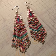 Stunning long metallic handmade seed earrings made with super bright square silver seed beads with pink, turquoise and soft matte pastel multicolored 11/0 seed beads. The earrings have long flowing fringe. The french hook earwires and findings are sterling silver. These gorgeous Cheyenne style earrings are super long and brush your shoulders ever so slightly. Great for daywear and stunningly beautiful for the night out. Earrings measure approximately 3-1/2 inches including ear wires. All items a Nickel-free Multicolor Heishi Beads Jewelry, Bohemian Nickel-free Heishi Beads Earrings, Pink Dangle Beaded Earrings With Spacer Beads, Adjustable Multicolor Earrings With Spacer Beads, Adjustable Multicolor Earrings With Silver Beads, Bohemian Pink Earrings With Spacer Beads, Bohemian Pink Jewelry With Spacer Beads, Multicolor Drop Earrings With Spacer Beads, Handmade Multicolor Heishi Beads Earrings