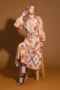 A printed woven midi dress featuring shirt collar, button down, long sleeve with cuff, self sash tie and full skirt Details: Self : 100% Polyester Size & Fit - Model is 5`8" And Wearing Size Small- Measurements Taken From Size Small- Approx. Length: 50" Fall Beige Dress With Belted Cuffs, Beige Fall Dress With Belted Cuffs, Beige Long Sleeve Dress With Belted Cuffs, Brown Long Sleeve Shirt Dress For Spring, Spring Beige Dress With Belted Cuffs, Brown Long Sleeve Printed Maxi Dress, Brown Printed Long Sleeve Maxi Dress, Beige Spring Dress With Belted Cuffs, Spring Beige Dresses With Belted Cuffs