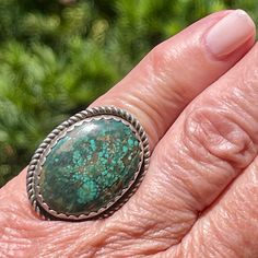 Lovely old vintage Navajo ring with a twisted rope-edge design.  The oval green turquoise stone is in a handmade scalloped bezel and set on a narrow, split-shank band.  Simple and beautiful. DETALS: Artist: unsigned, Navajo Ring Size: 6 Design size: 1 1/4" long x 1" wide Weight: 12.8 grams, .45 oz Materials: Sterling silver & turquoise Condition: From a private collection LC71 Untreated Oval Turquoise Ring, Green Oval Turquoise Artisan Ring, Oval Gemstone Western Rings, Western Style Oval Gemstone Rings, Bohemian Oval Rings With Patina, Bohemian Oval Turquoise Collectible Ring, Untreated Adjustable Oval Turquoise Ring, Vintage Green Turquoise Oval Cabochon Ring, Western Style Untreated Oval Turquoise Ring