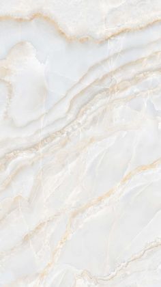 a white marble textured surface with gold veining